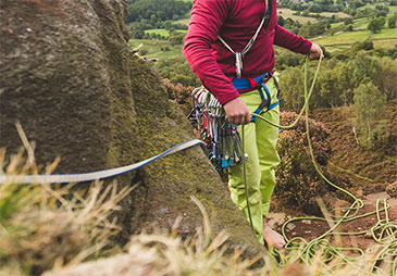 A man pulling a climbing rope